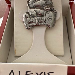 Adorable Alexis kitten asleep on an armchair brooch.